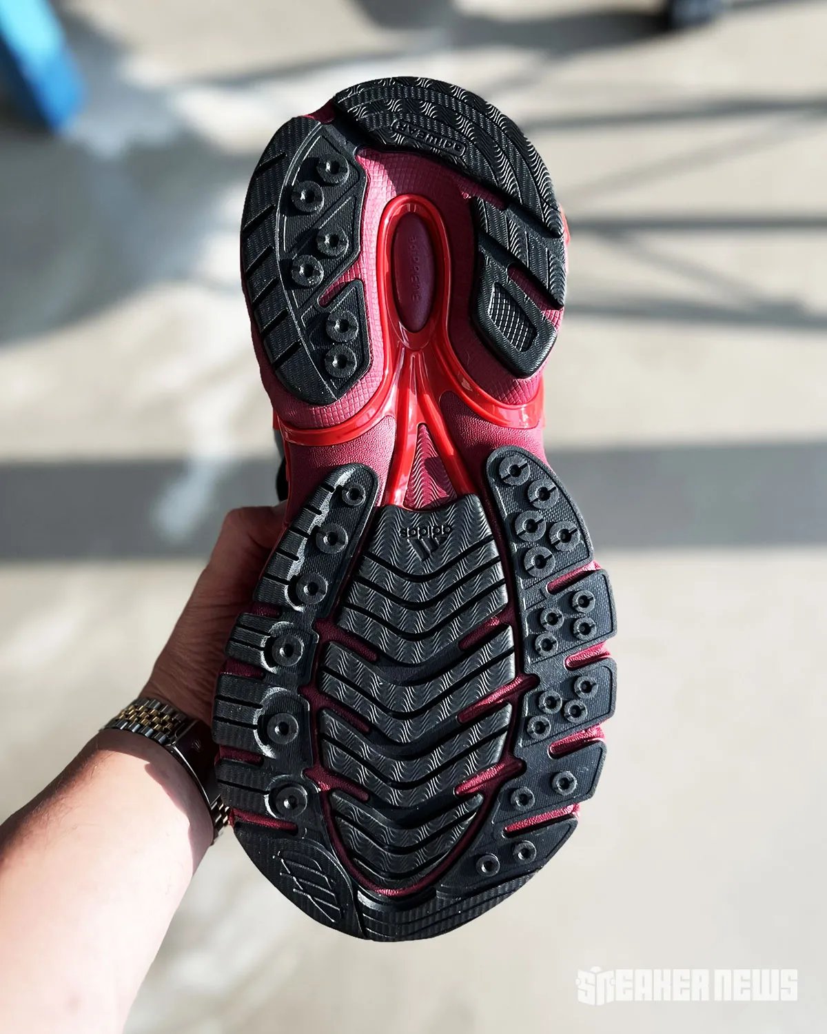 Pharrell's adidas VIRGINIA Jellyfish in red colorway with grey tentacle accents and black Three Stripes - detail view 3