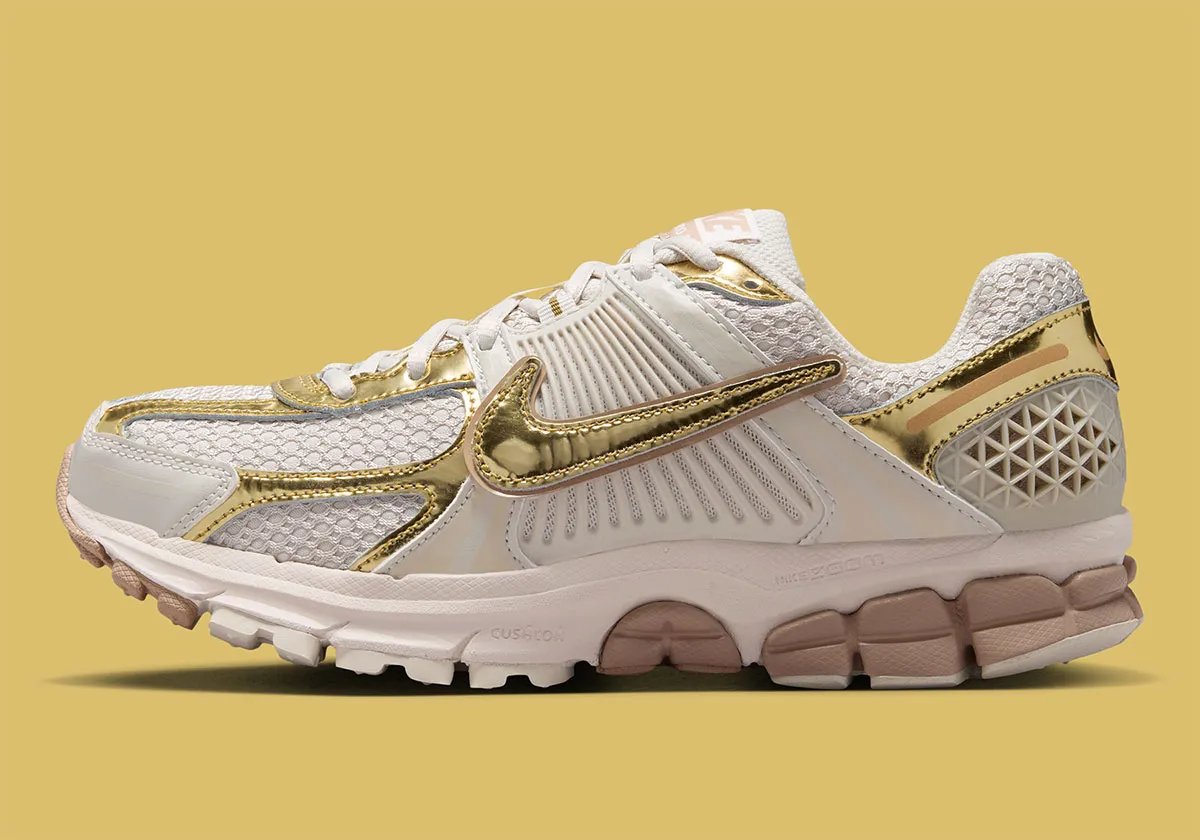 Nike Zoom Vomero 5 Metallic Gold colorway with rosy Swoosh detailing and metallic accents on upper - detail view 1