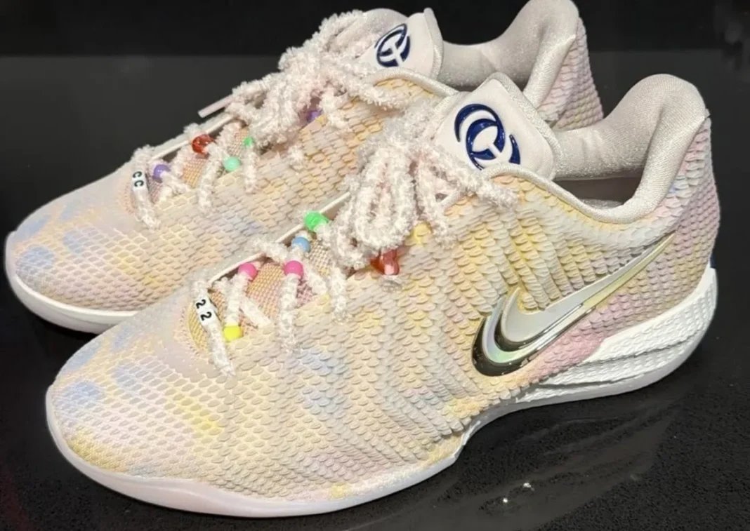 Nike Caitlin 1 'Friendship Bracelet' in Pearl Pink and Racer Blue with iridescent upper and charm-adorned laces, inspired by Taylor Swift's Eras Tour aesthetic