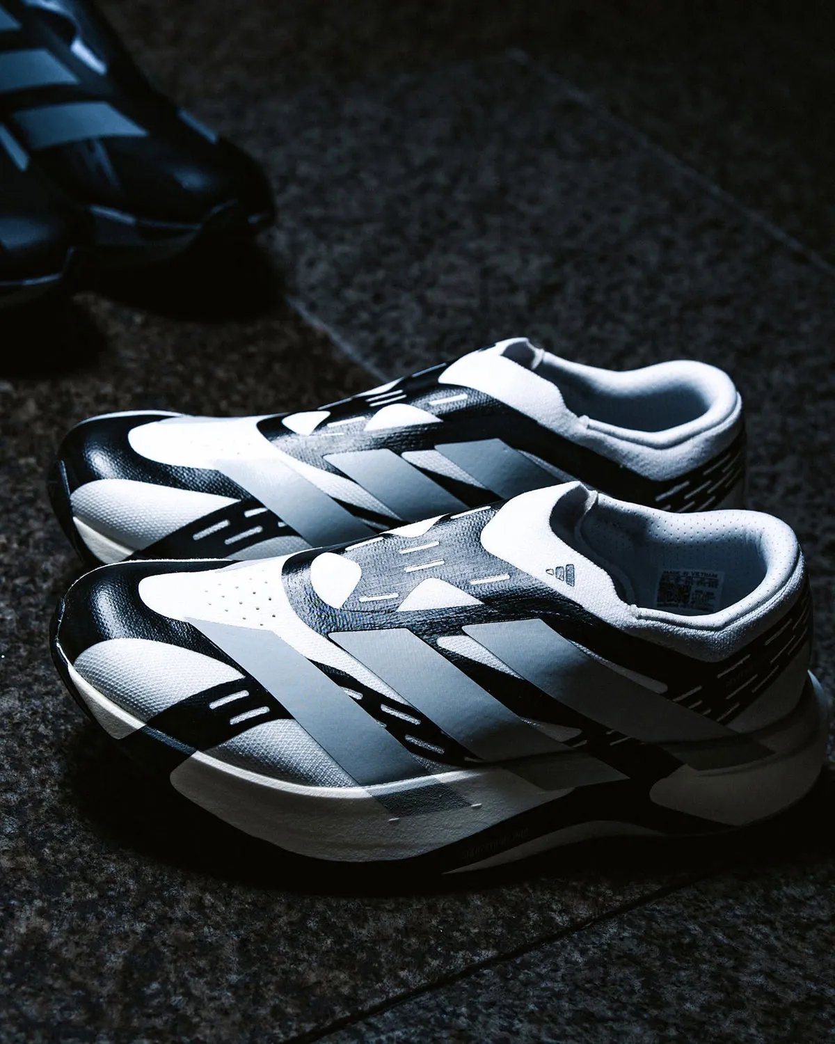 adidas EVO SL Laceless in profile, showing reinforced synthetic layers and minimal sock-collar construction - detail view 2