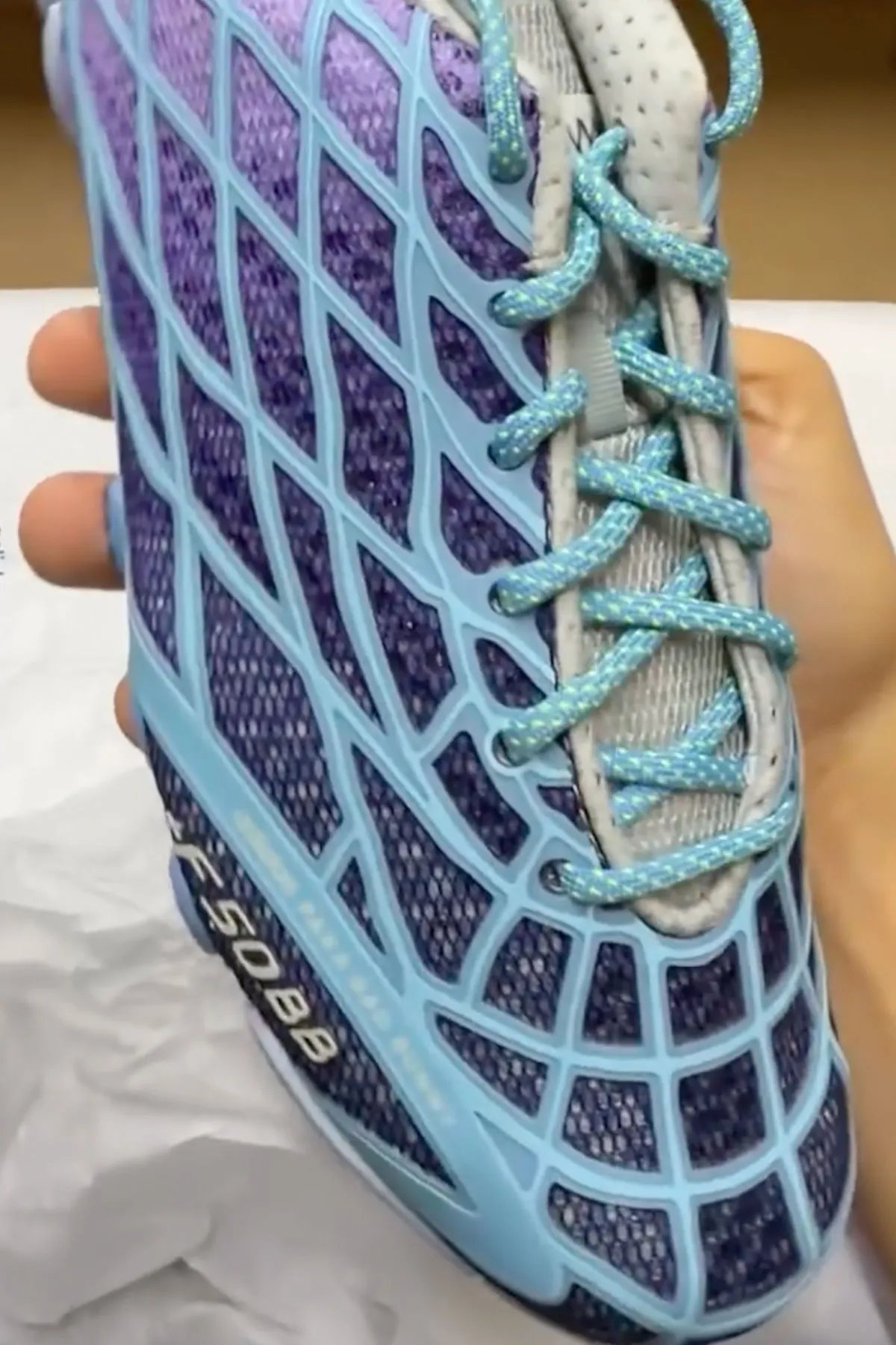 Bad Bunny x adidas F50 Ghost Sprint in purple and blue gradient colorway, showing F50 TPU skeletal upper paired with Ghost Sprint track outsole - detail view 1
