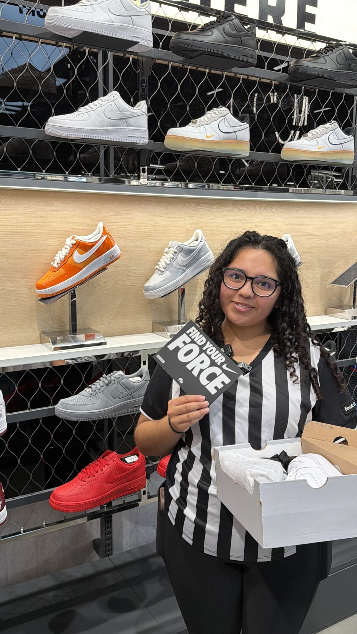 Nike Air Force 1 displayed in Foot Locker retail setting with employee engagement - detail view 3