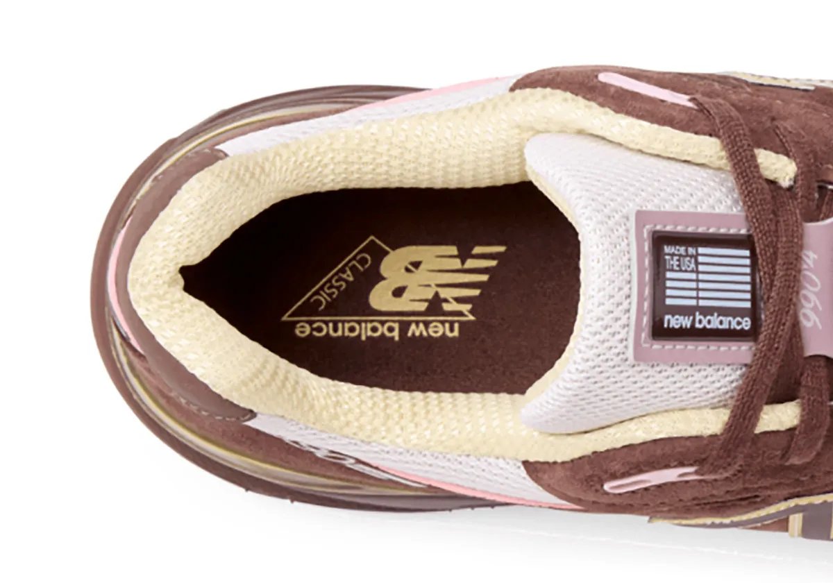 New Balance 990v4 Pumpernickel colorway featuring brown suede upper with pink mesh and yellow N logo trim - detail view 2