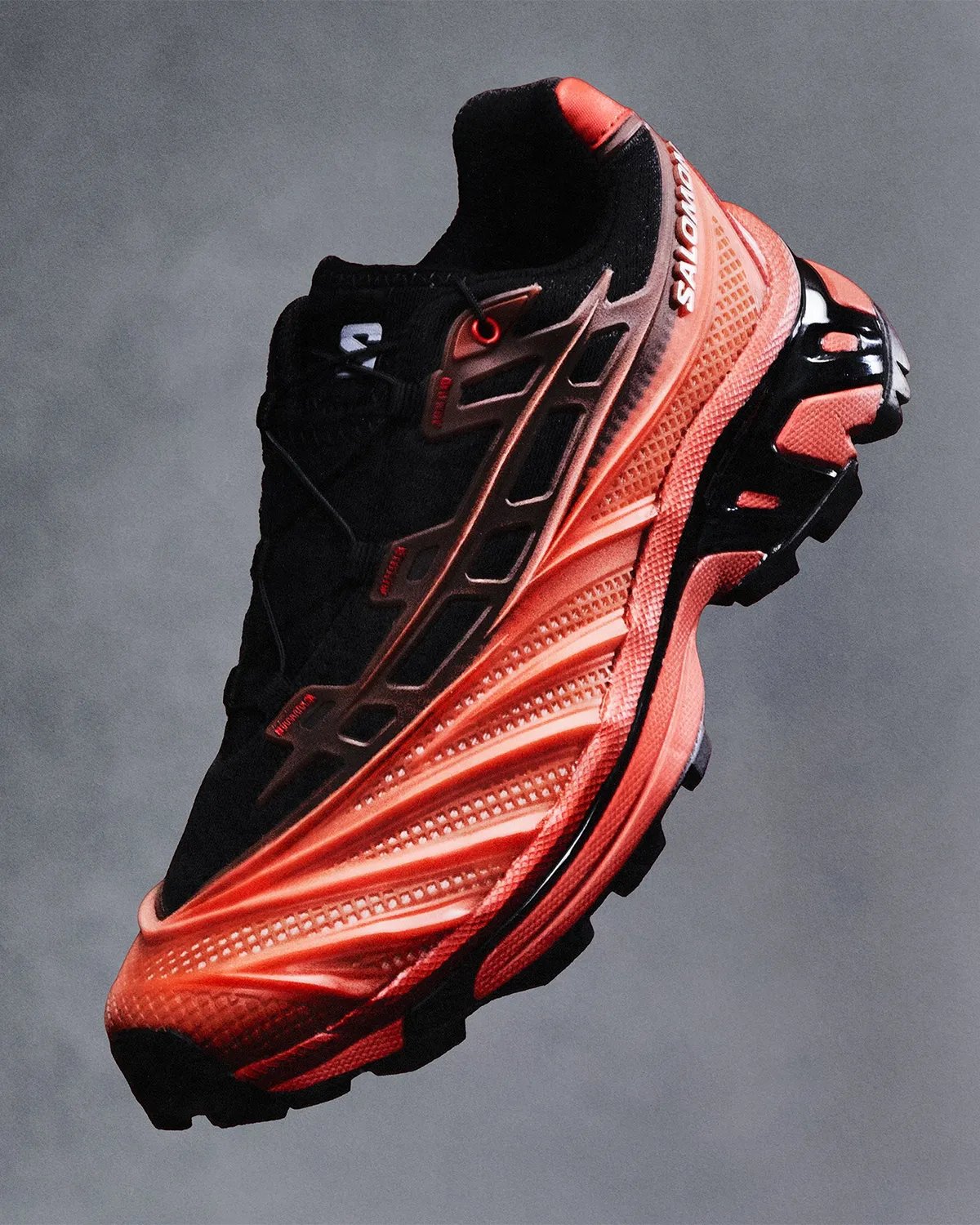 Salomon XT-EVO featuring liquid rubber cage construction in Black/Fiery Red colorway - detail view 2