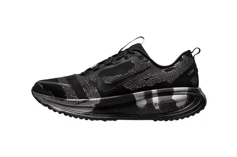 Nike Vomero 18 DSRPT in Iron Grey, Light Smoke Grey, and Black colorway showing abstract two-tone design on running shoe upper - detail view 2