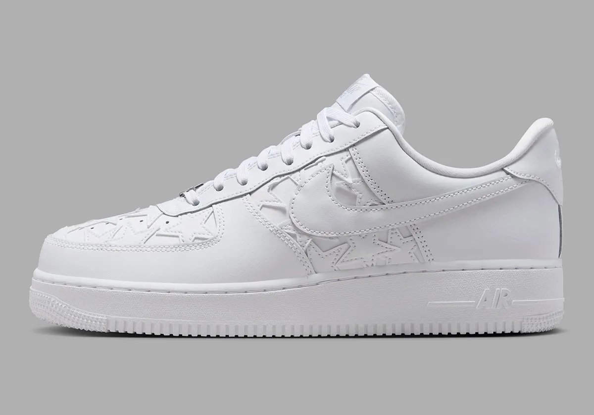 Nike Air Force 1 Low in Triple White with star-motif leather patches on the quarter panel and toe box - detail view 1