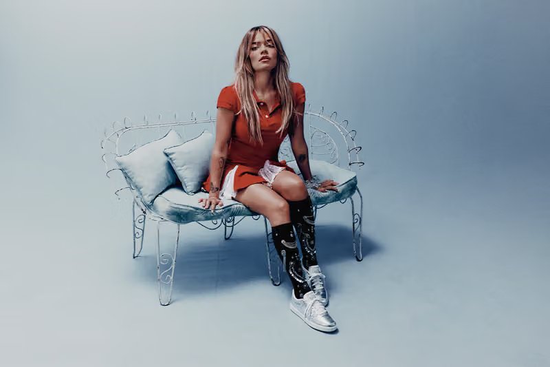 Karol G wearing Reebok Classics in the 'Born Classic. Worn Together.' campaign, shot in Mexico City with warm sunset tones reflecting her Tropicoqueta era - detail view 3