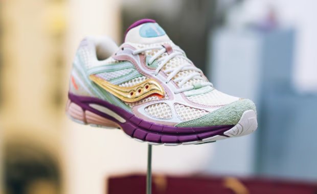Stan Birch x Saucony ProGrid Guide 7 pastel collaboration featuring off-white mesh, soft green suede toe, and deep purple heel accents