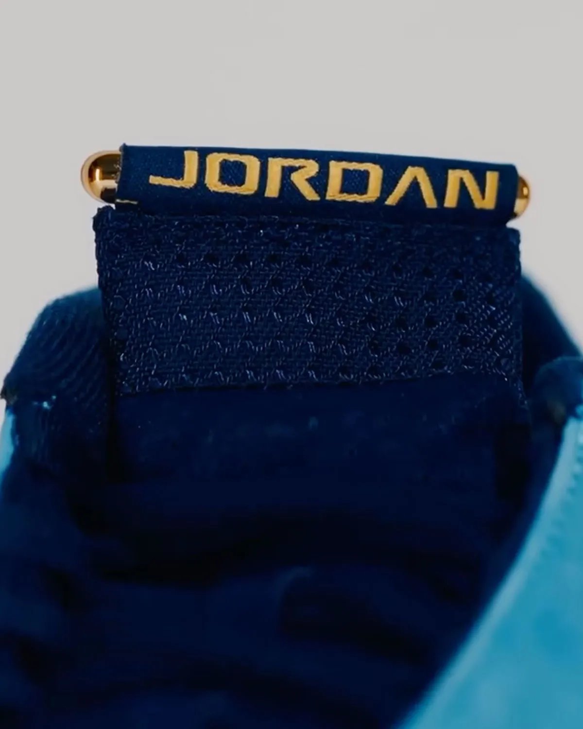 Marquette Air Jordan 14 PE in monochromatic suede with gold midsole vents and carbon fiber overlays - detail view 4