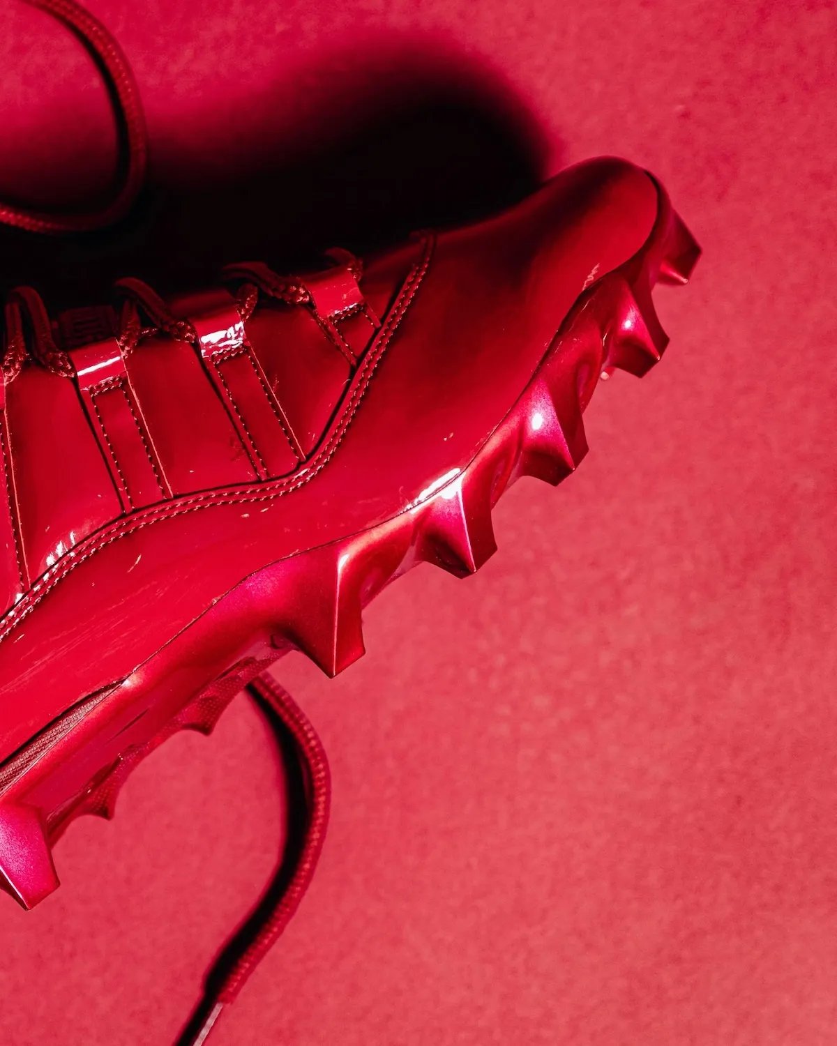 Oklahoma Sooners Air Jordan 11 football cleat in all-crimson colorway with black Jumpman logos - detail view 5