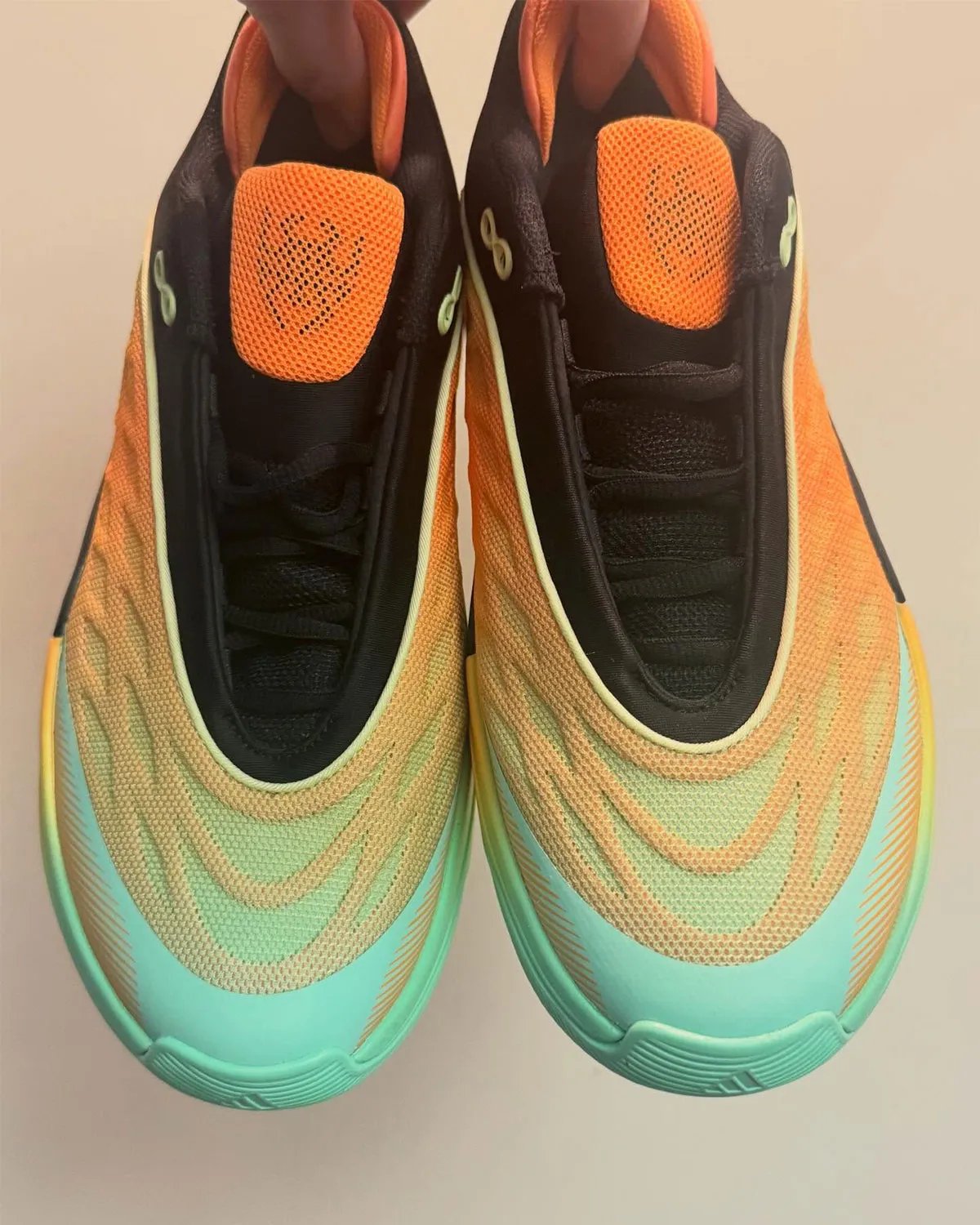 adidas D.O.N. Issue 8 in Lucid Tangerine, Core Black, and Pulse Mint colorway showing low-cut silhouette with webbed overlay system - detail view 2