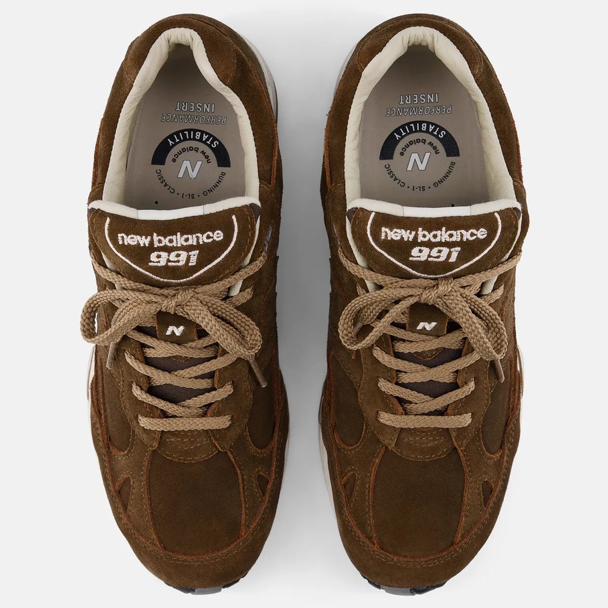 New Balance 991v1 in Coffee Suede colorway featuring premium pig suede upper with earthy brown tones and white/black sole unit - detail view 2