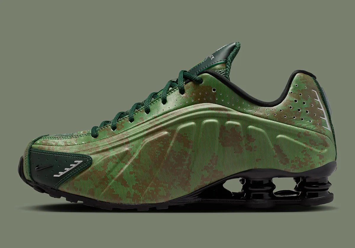 Nike Shox R4 in Team Kelly Green and Rough Green camo with all-black Shox cushioning unit and tactile mini Swoosh detail - detail view 1