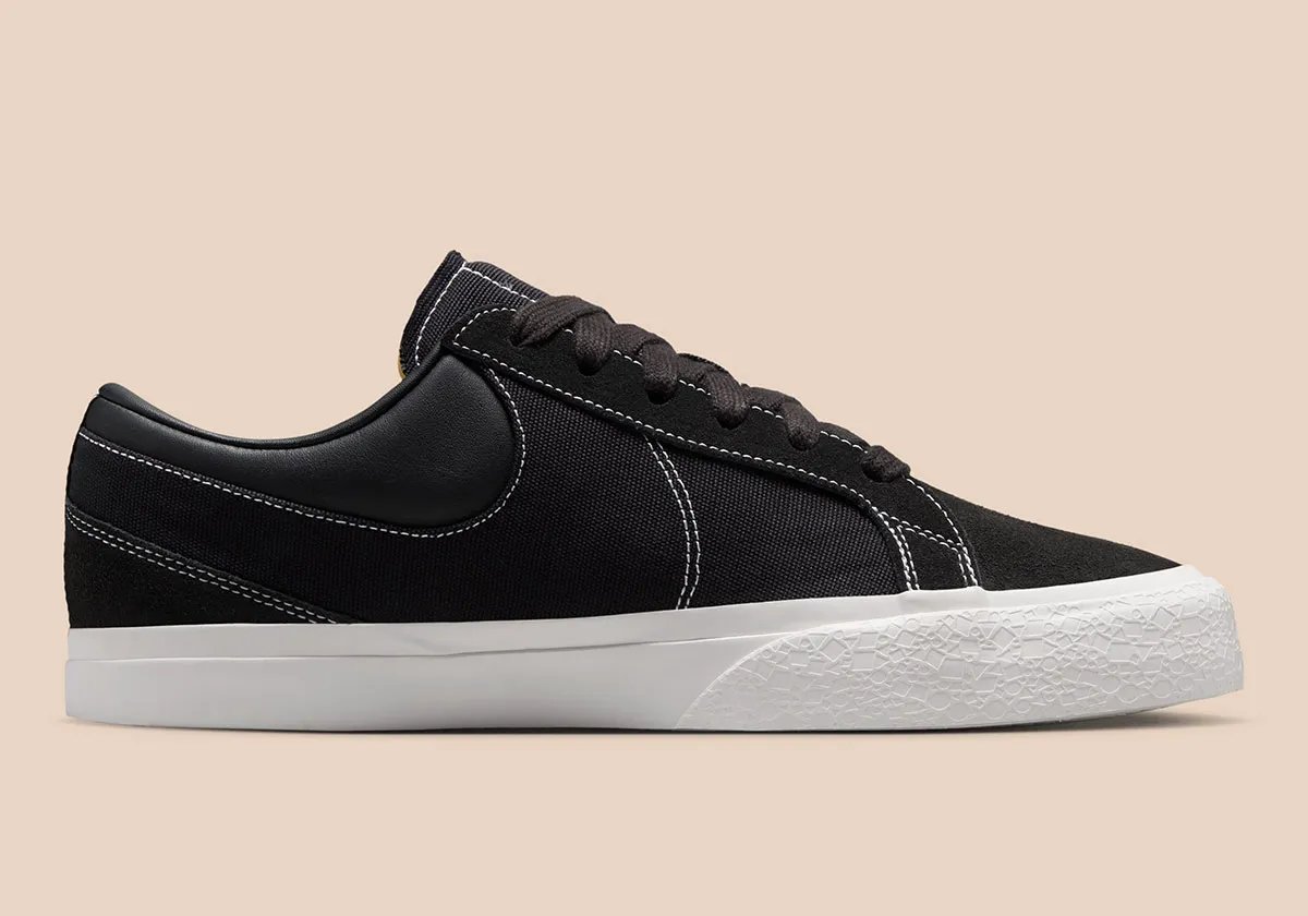 Nike Blazy in Sail colorway, showing exaggerated heel drag and curved Swoosh stitching detail on canvas panels - detail view 3
