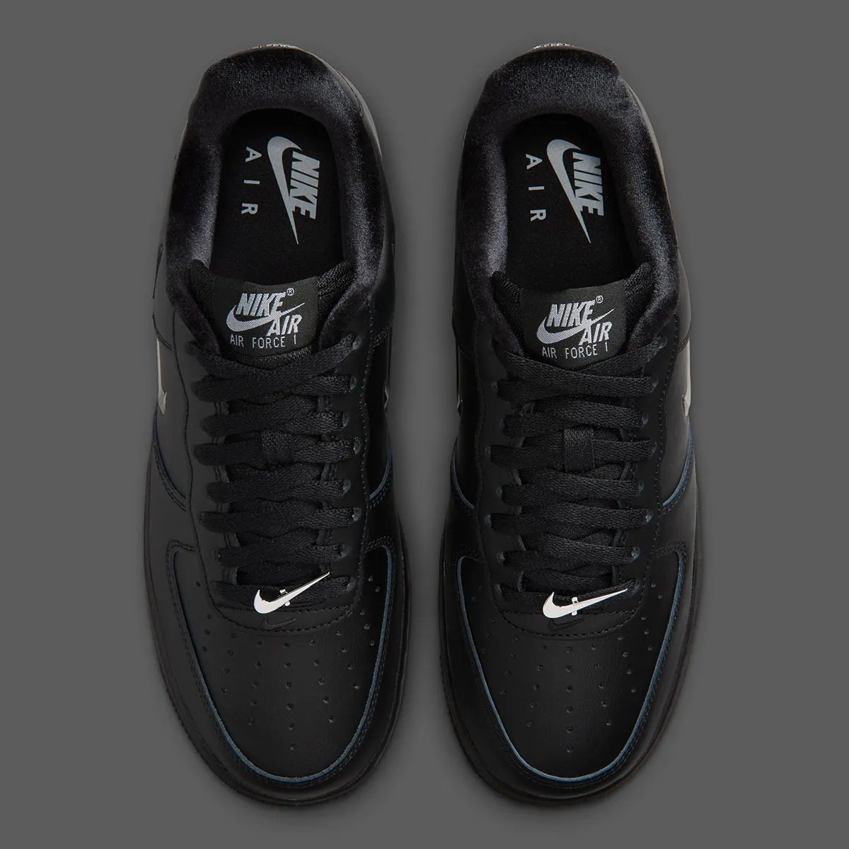 Nike Air Force 1 Low in black leather with chrome silver Swoosh detail, side view - detail view 3