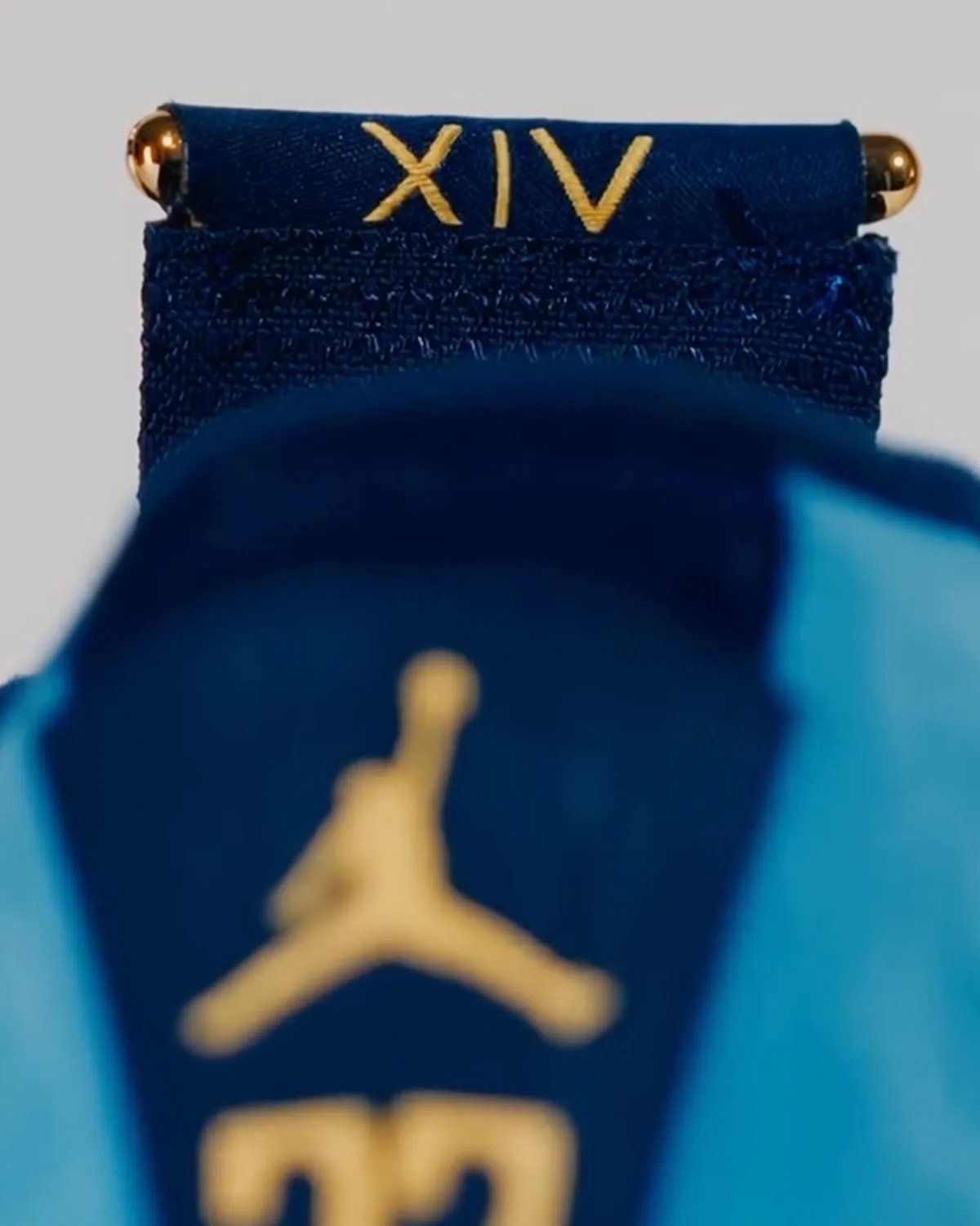 Marquette Air Jordan 14 PE in monochromatic suede with gold midsole vents and carbon fiber overlays - detail view 3