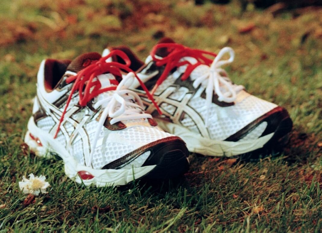 NAKED x ASICS GEL-Cumulus 16 in Scandinavian Sunset colorway showing white mesh upper with brown panels and red accent details - detail view 1