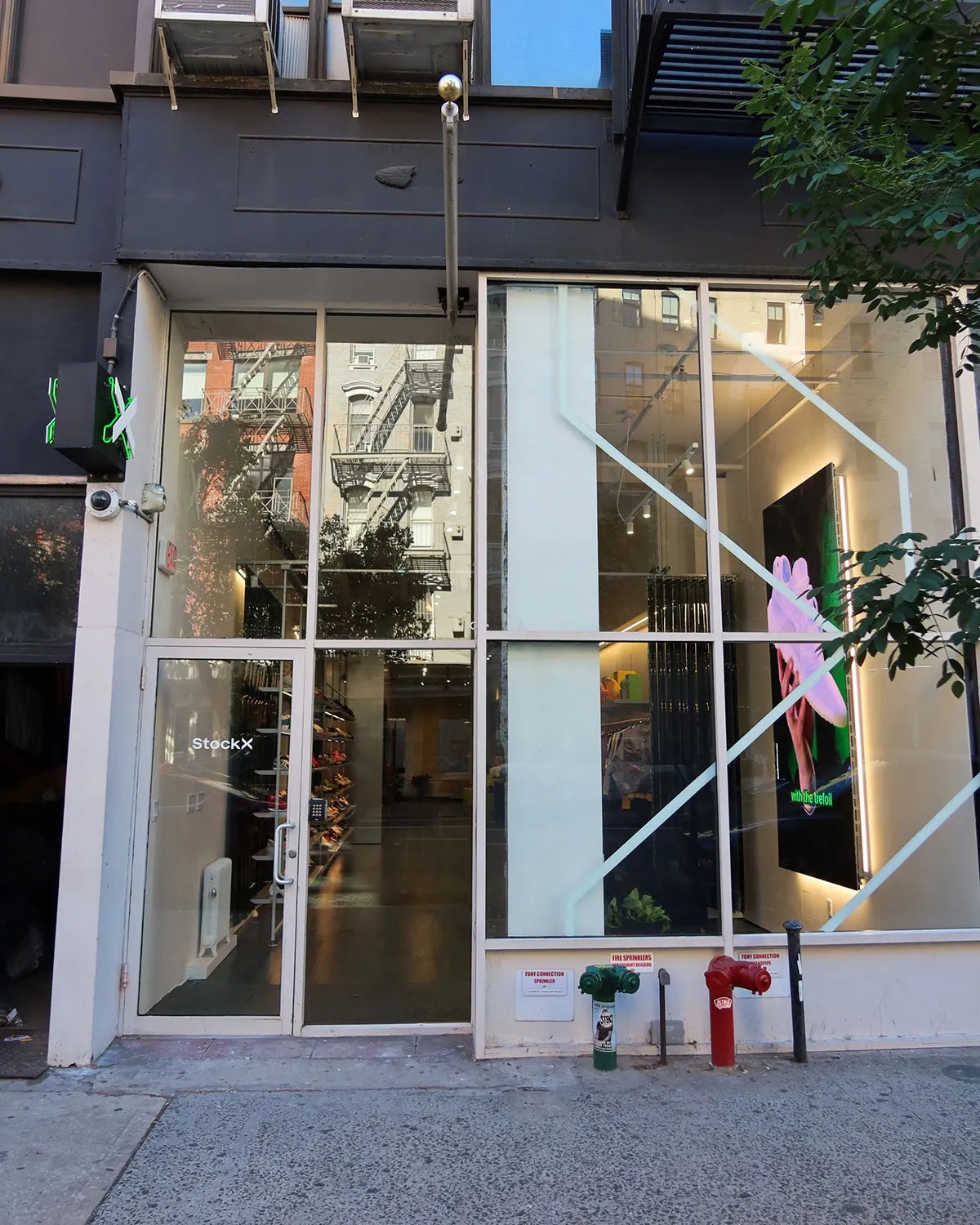 Interior view of StockX's renovated NYC flagship store in SoHo, displaying sneaker inventory and retail display fixtures - detail view 1