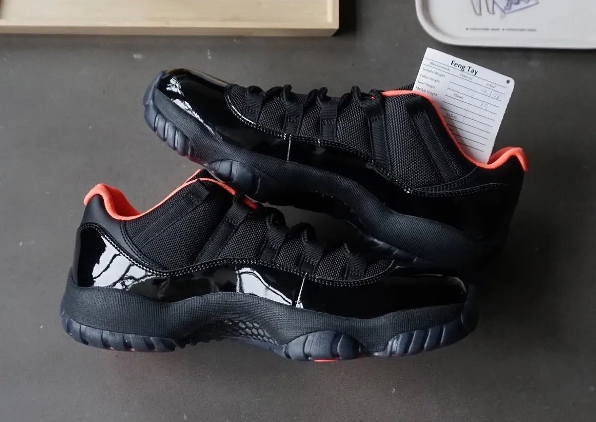 Air Jordan 11 Low Black Infrared sample featuring all-black patent leather upper with infrared sockliner and Jumpman branding - detail view 3