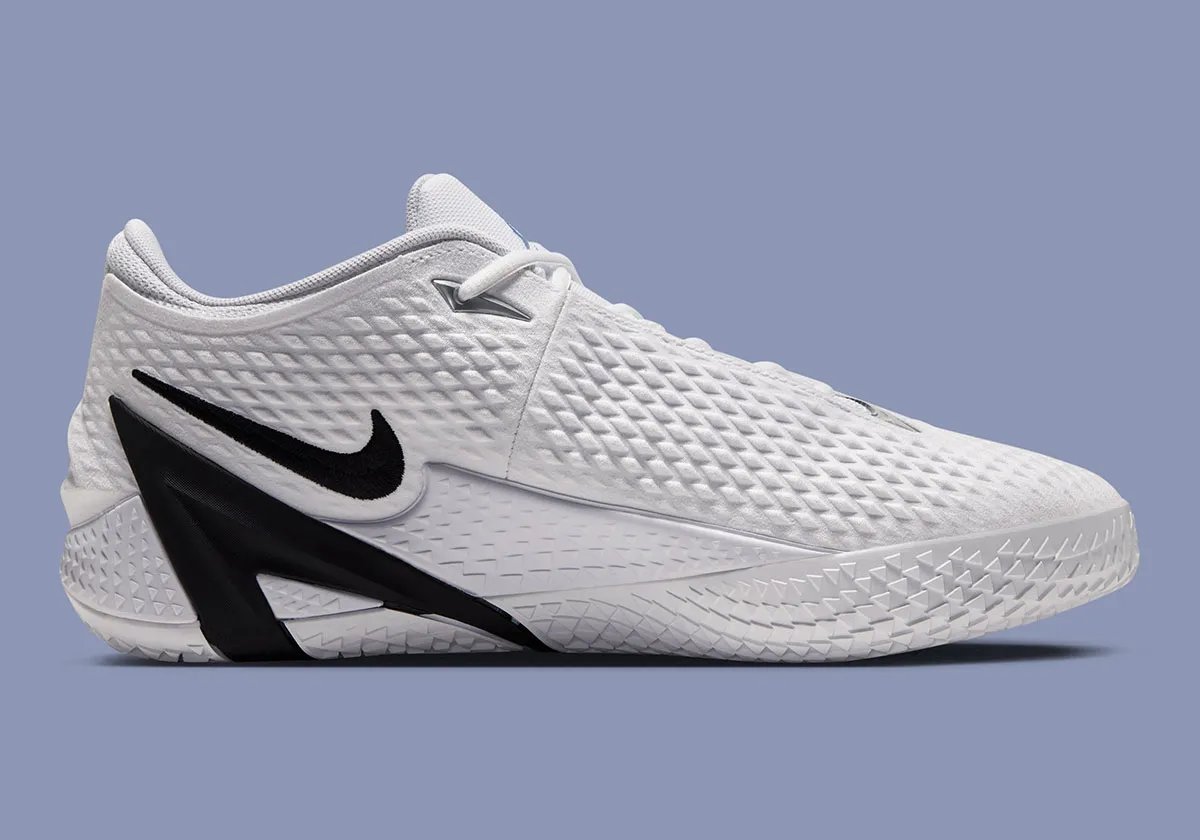 Nike Ja 4 in White with Cobalt Bliss, Photon Dust, and Black colorway, showing the white upper, black Swoosh, and A-Frame detail - detail view 2