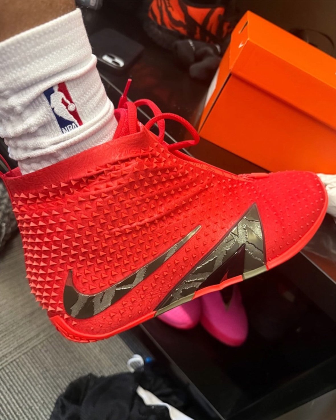 Nike Ja 4 High with wrapped exterior shell and triangular branding detail in high-top silhouette - detail view 3