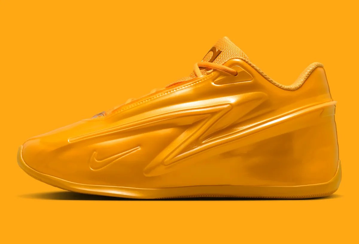 Nike KD 19 'Butter Candy' in solar flare golden-yellow, showing the full lateral silhouette with molded side panels and exaggerated heel platform - detail view 3