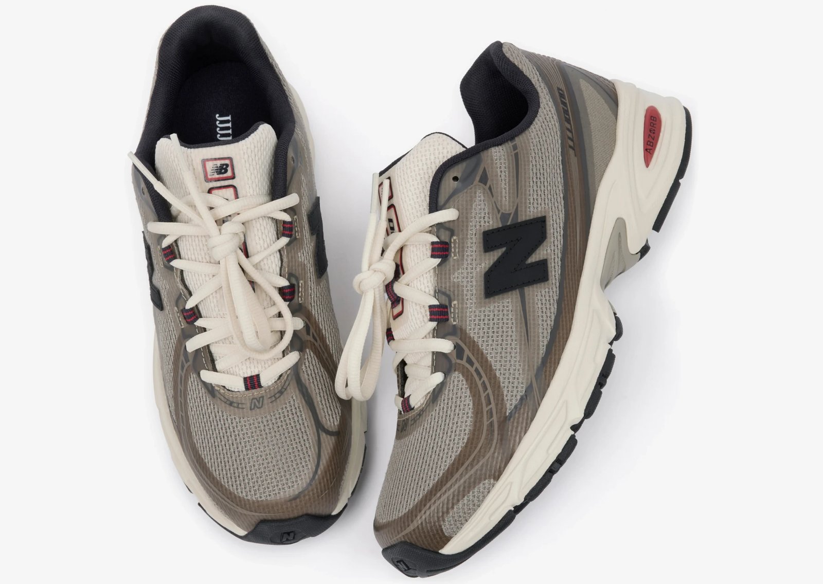 JJJJound x New Balance 740N in tan, taupe, and beige earth tones with off-white mesh tongue and navy accents - detail view 1