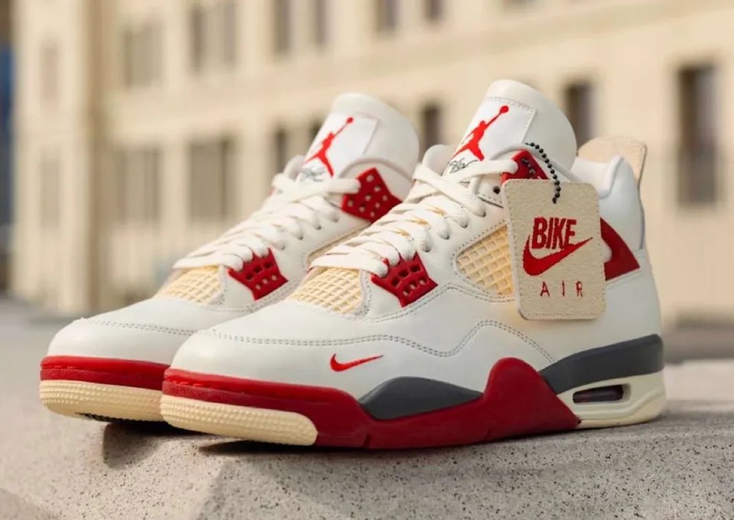 Nigel Sylvester x Air Jordan 4 'Brick After Brick' in Sail, Anthracite, Muslin and Cinnabar colorway, side view showing mesh paneling and flight wings detail - detail view 1