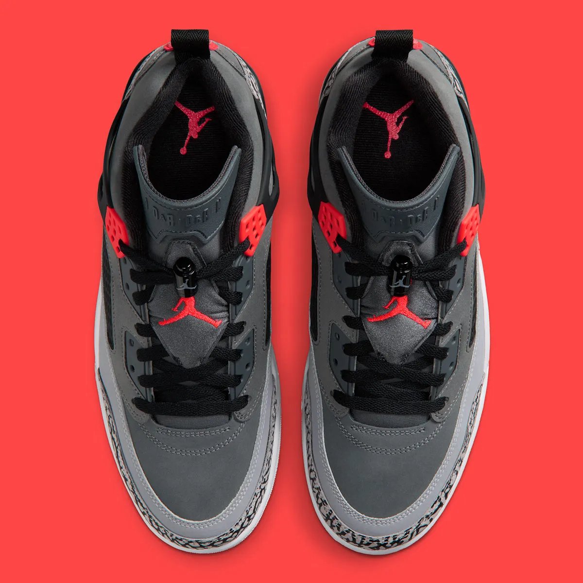 Jordan Spiz'ike Low in Infrared colorway, side profile view showing mixed-material upper construction and distinctive lace toggle detail - detail view 4