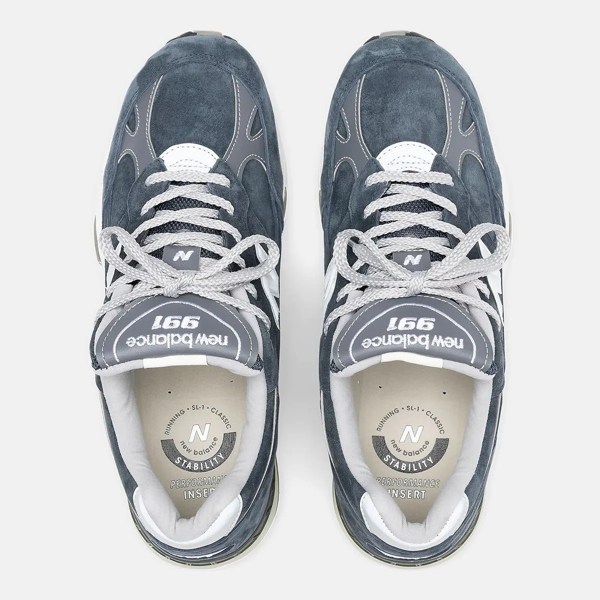 New Balance 991 Essential in black and navy colorways featuring premium nubuck uppers and white contrast sole units - detail view 3