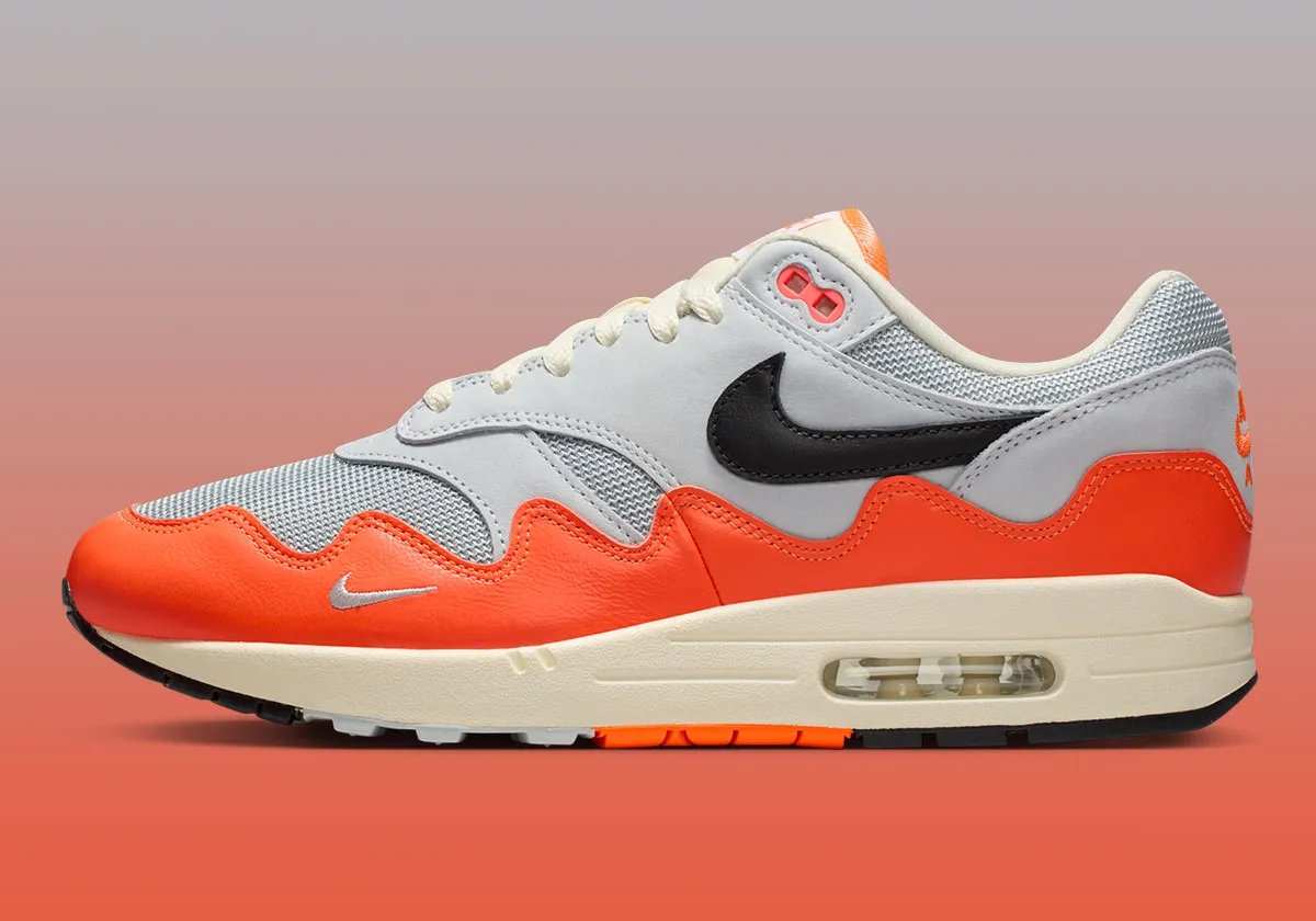 Patta x Nike Air Max 1 Hyper Crimson sneaker, side profile view showing exposed Air unit and classic silhouette - detail view 1