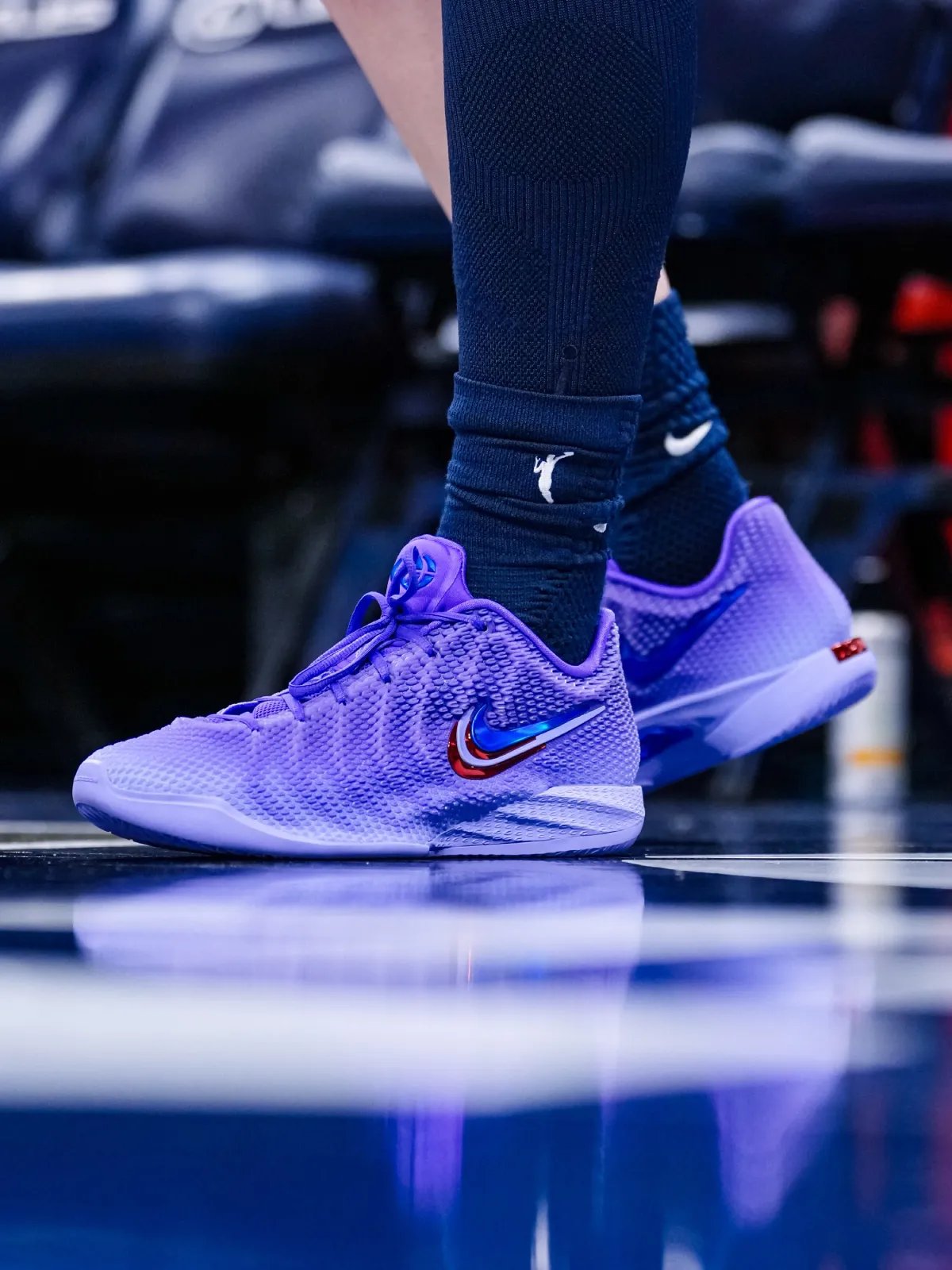 Caitlin Clark wearing the Nike Caitlin 1 in lavender purple with layered Swoosh details during WNBA game - detail view 4