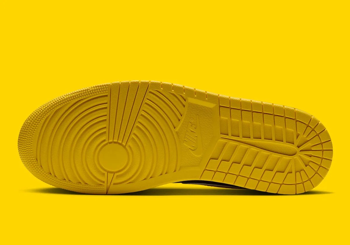 Air Jordan 1 Low in Tour Yellow with black leather upper, Tour Yellow Swoosh, and speckled white midsole - detail view 2