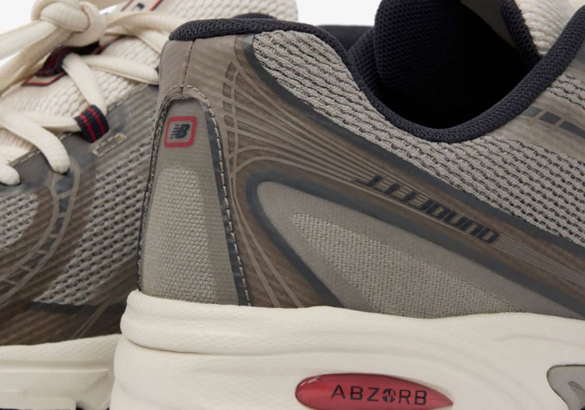 JJJJound x New Balance 740N in Mushroom colorway, featuring no-sew construction with beige, taupe, and off-white upper, navy eyelets, and red accents - detail view 4