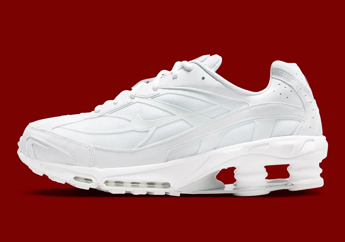 Nike Shox Ride 2 in Triple White colorway, showing full white upper, midsole, and visible Shox cushioning units - detail view 1