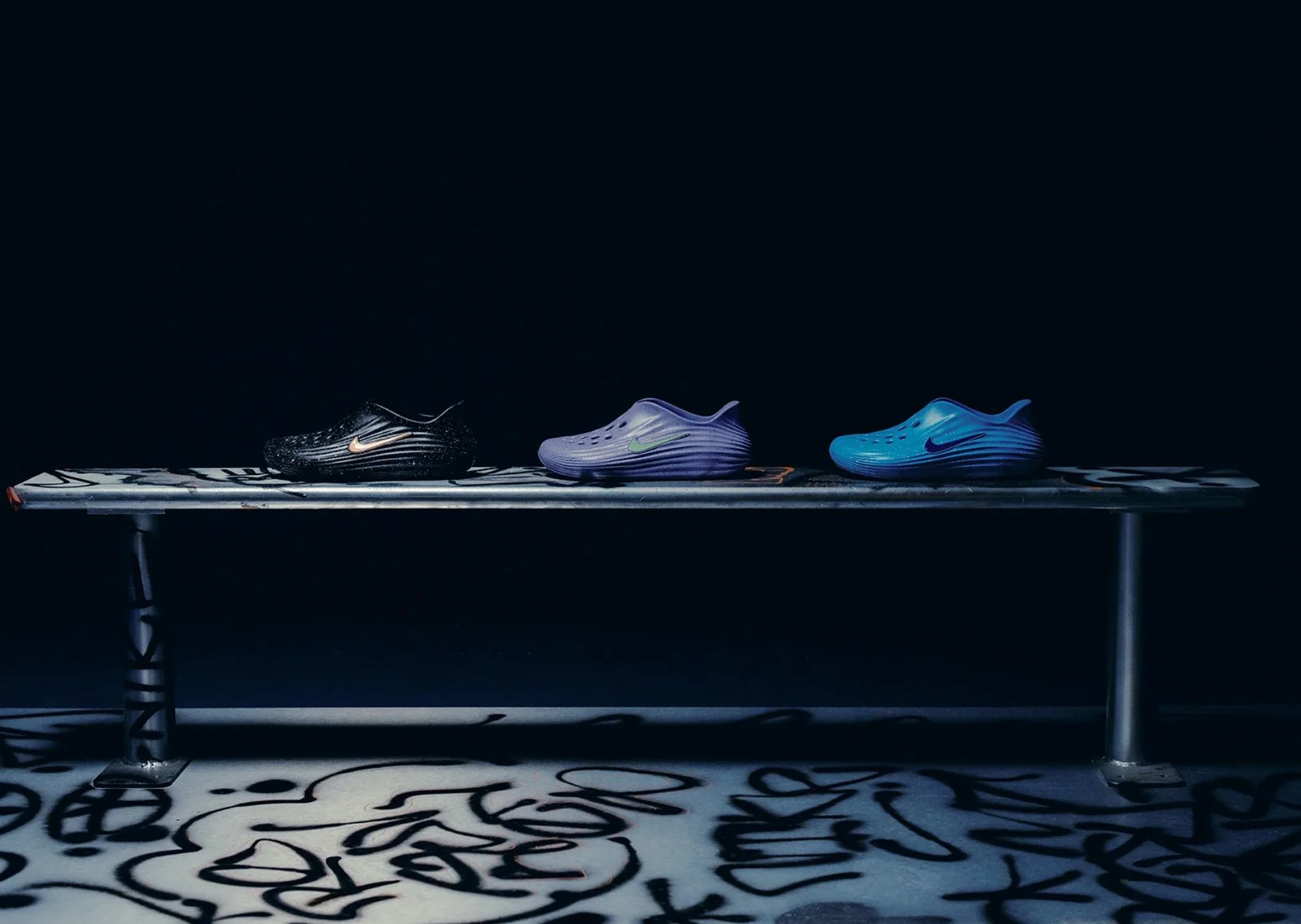 The Whitaker Group x Nike ReactX Rejuven8 Splatter Pack in Blue Drift, Black Signal, and Violet Rush colorways with contrasting paint splatter uppers - detail view 2