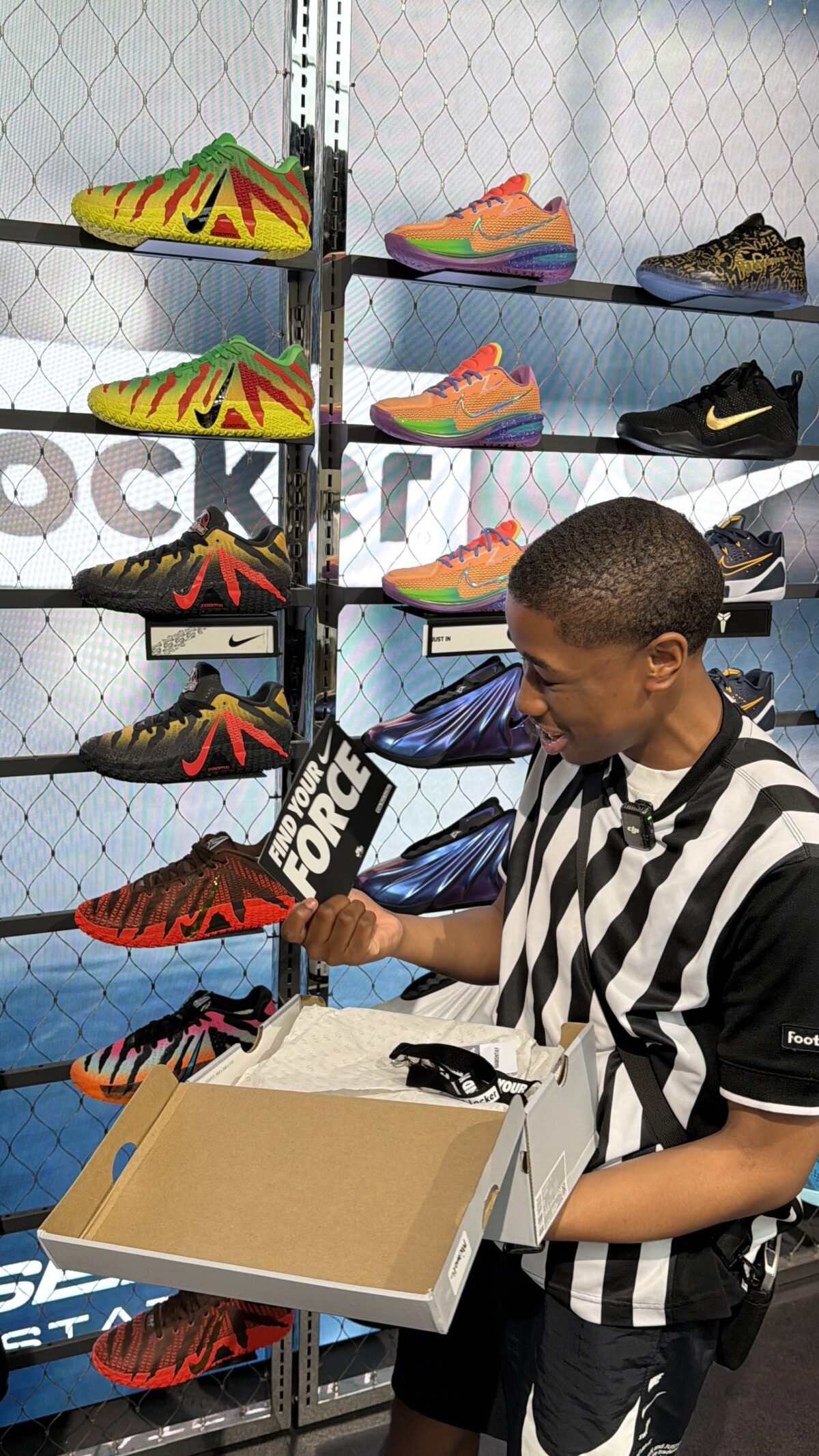 Nike Air Force 1 displayed in Foot Locker retail setting with employee engagement - detail view 1