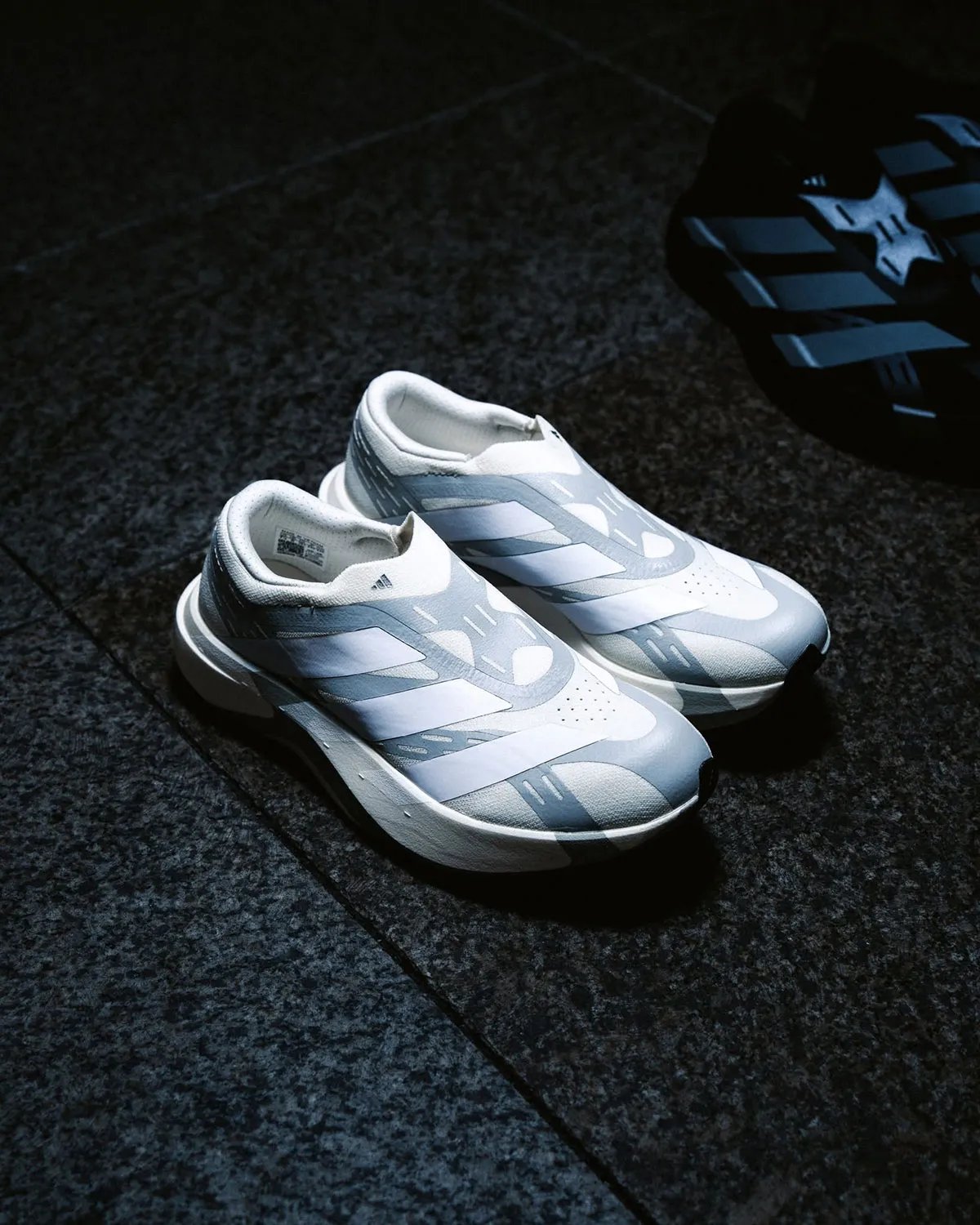 adidas EVO SL Laceless in profile, showing reinforced synthetic layers and minimal sock-collar construction - detail view 1