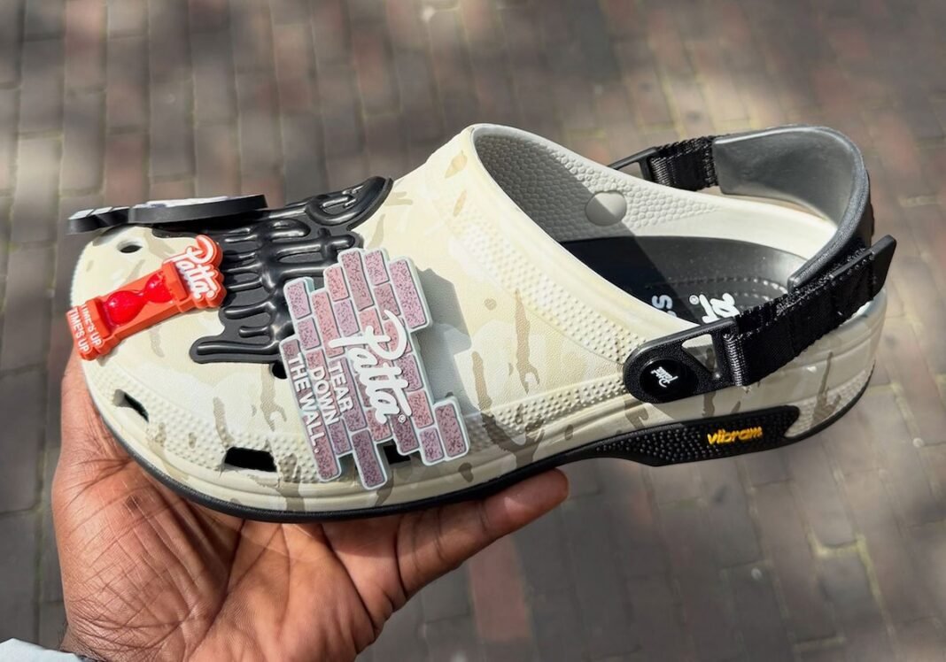 Patta x Crocs Classic EXP Clog featuring desert camouflage upper, Vibram outsole, and custom Jibbitz accessories