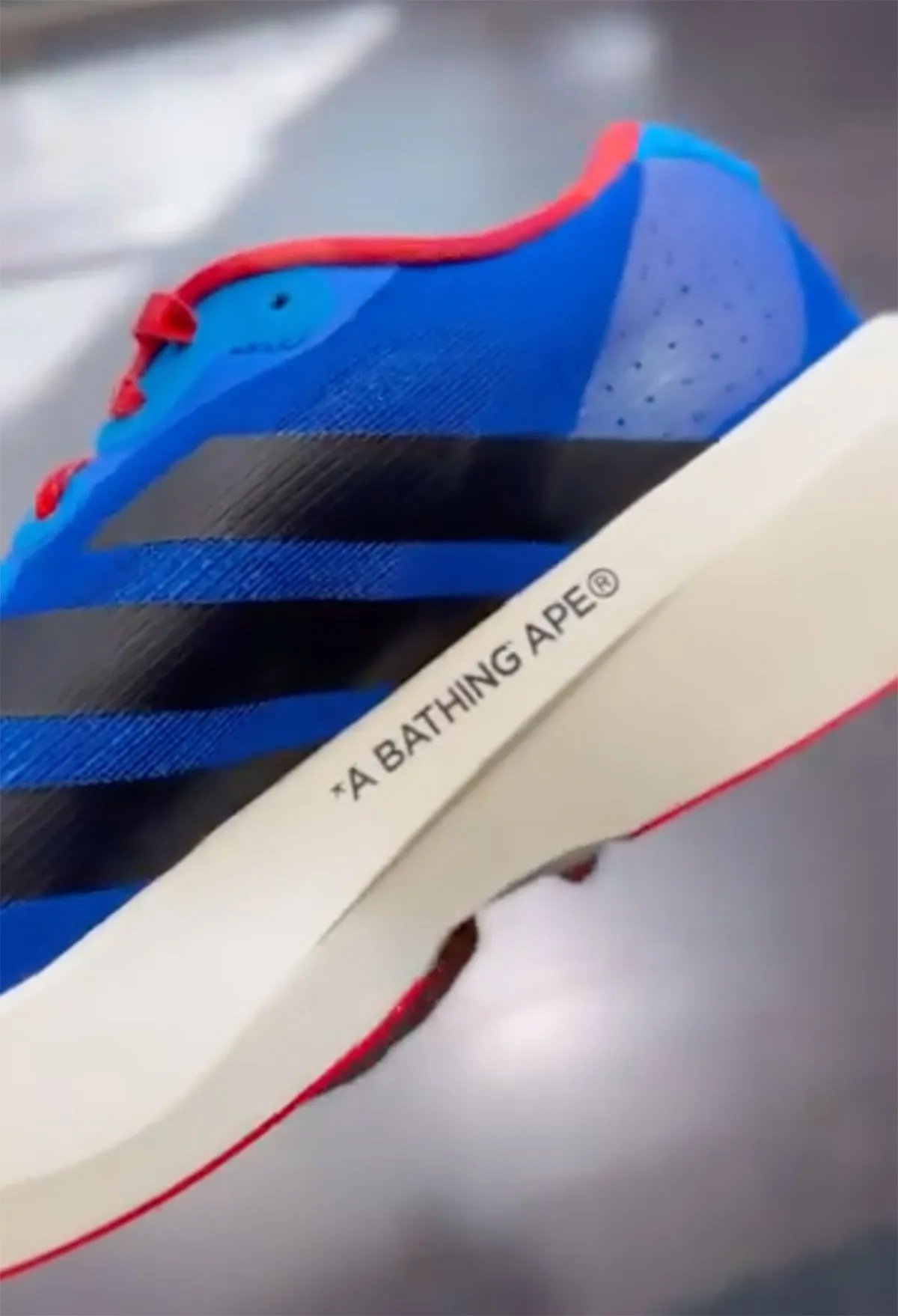 Bape x adidas Adizero EVO SL mismatched colorway featuring asymmetrical blue and green construction with inverted branding - detail view 2