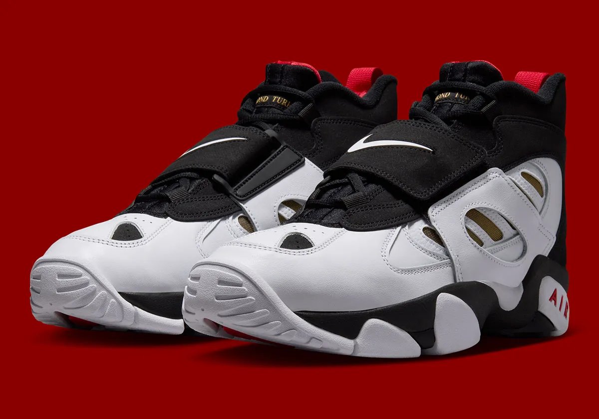 Nike Air Diamond Turf 2 '49ers' in black and white leather with red and gold accents, honoring Deion Sanders' 49ers season