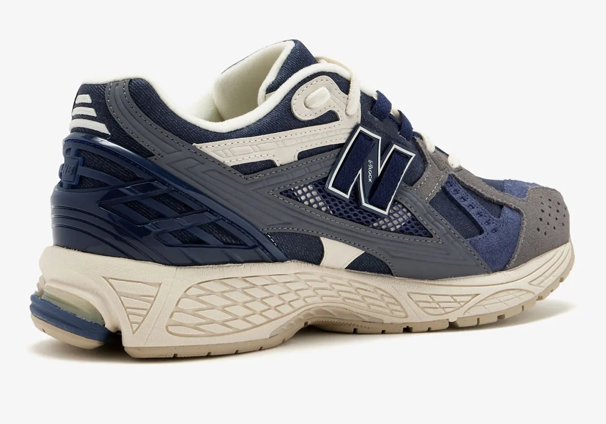 New Balance 1906U in navy and off-white colorway, showing side profile of the lifestyle sneaker - detail view 1