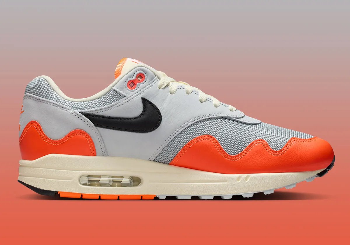 Patta x Nike Air Max 1 Hyper Crimson sneaker, side profile view showing exposed Air unit and classic silhouette - detail view 2