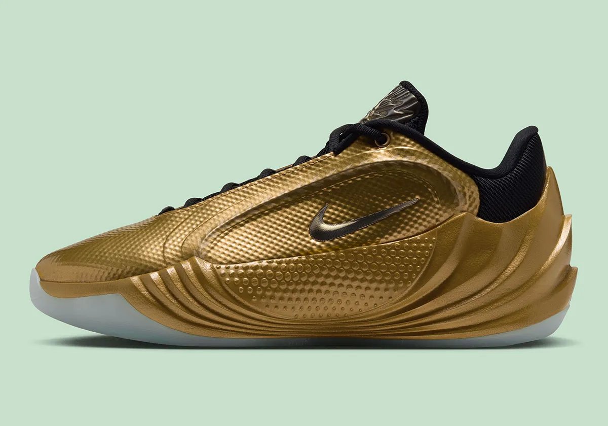 Nike Giannis Freak 8 Metallic Gold colorway featuring gold upper and midsole with black tongue and collar - detail view 1