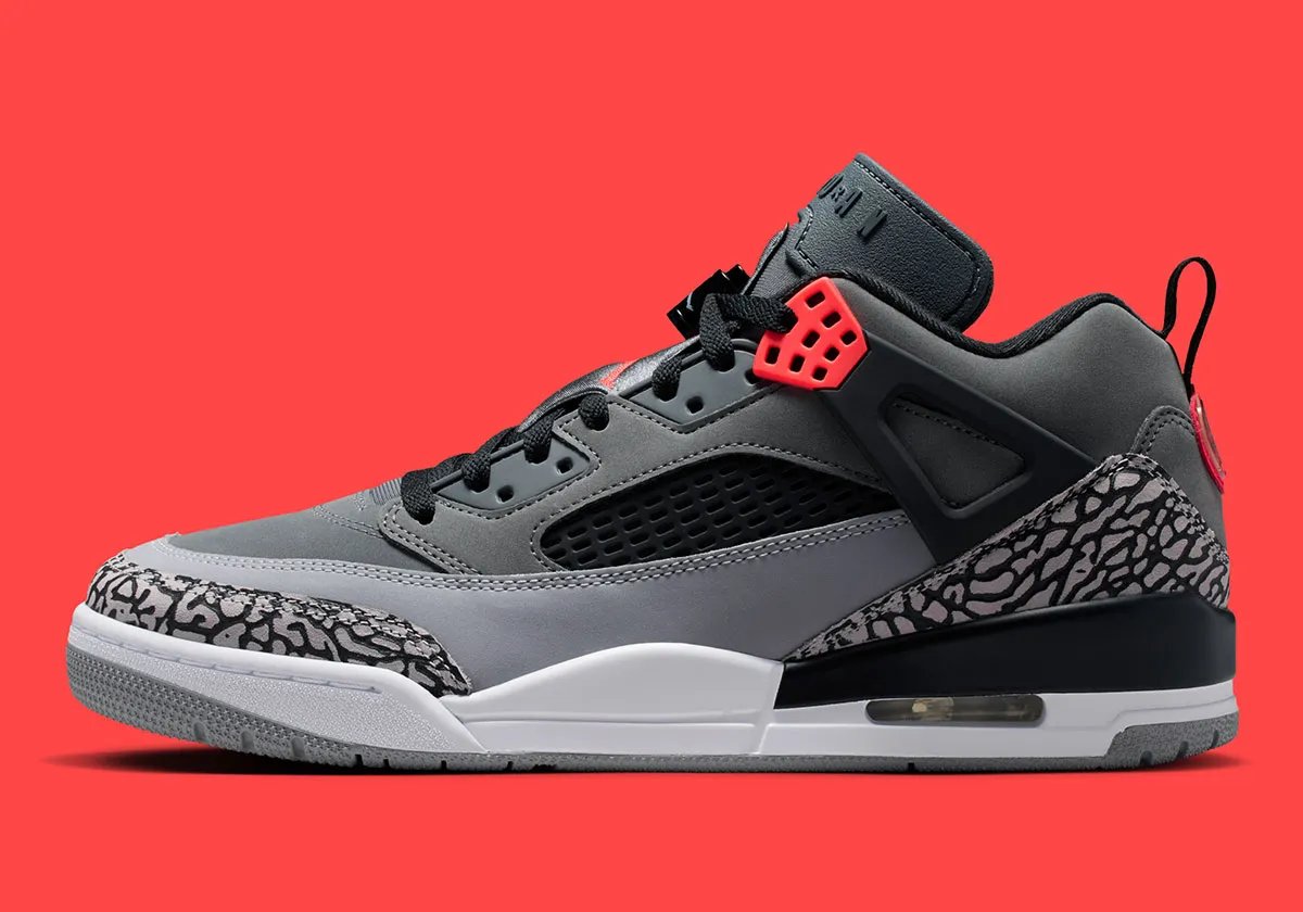 Jordan Spiz'ike Low in Infrared colorway, side profile view showing mixed-material upper construction and distinctive lace toggle detail - detail view 1