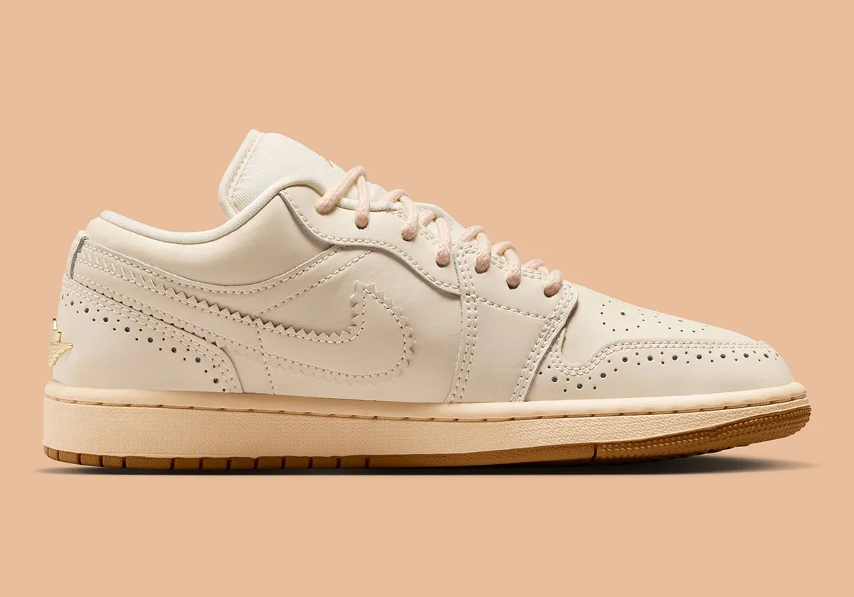Air Jordan 1 Low in Brogue colorway featuring off-white leather with gold embroidery and rope laces - detail view 2