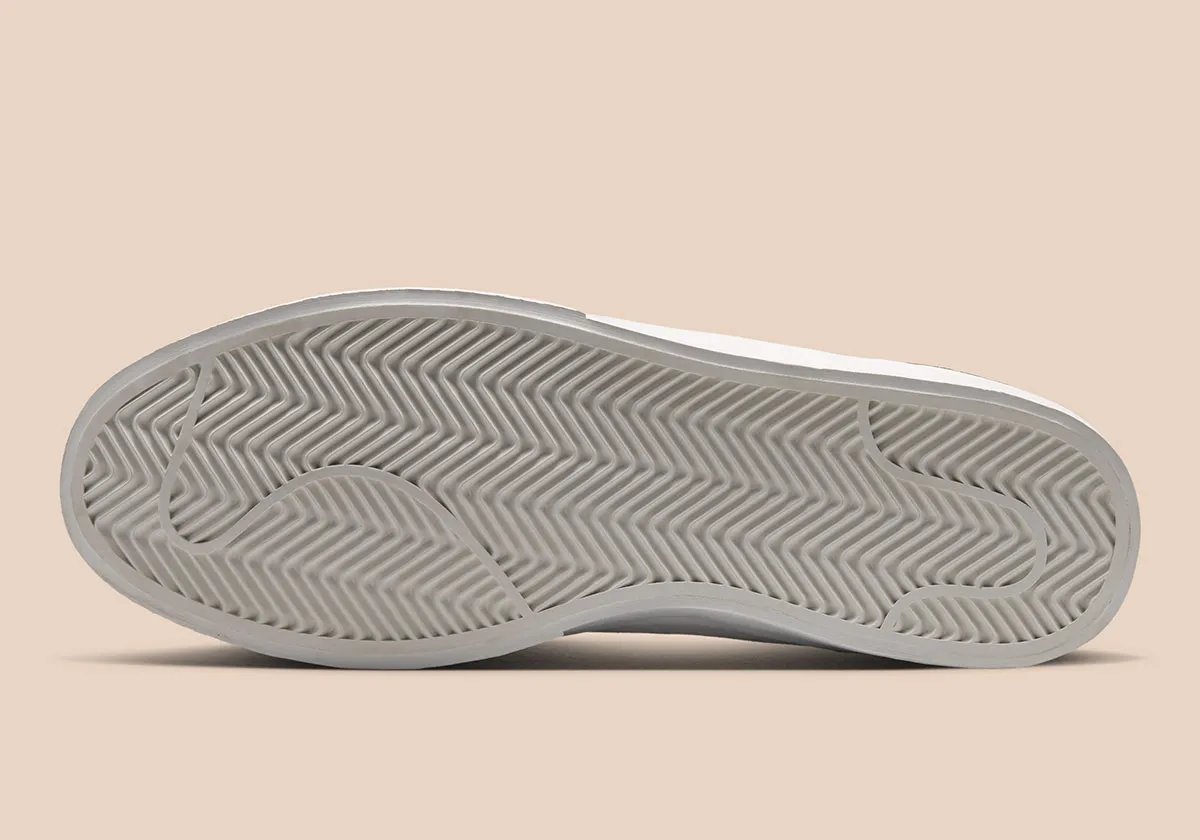 Nike Blazy in Sail colorway, showing exaggerated heel drag and curved Swoosh stitching detail on canvas panels - detail view 2