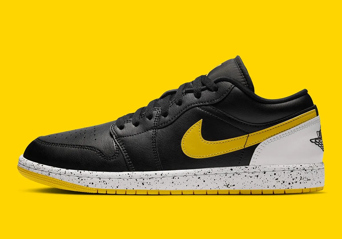 Air Jordan 1 Low in Tour Yellow with black leather upper, Tour Yellow Swoosh, and speckled white midsole - detail view 1