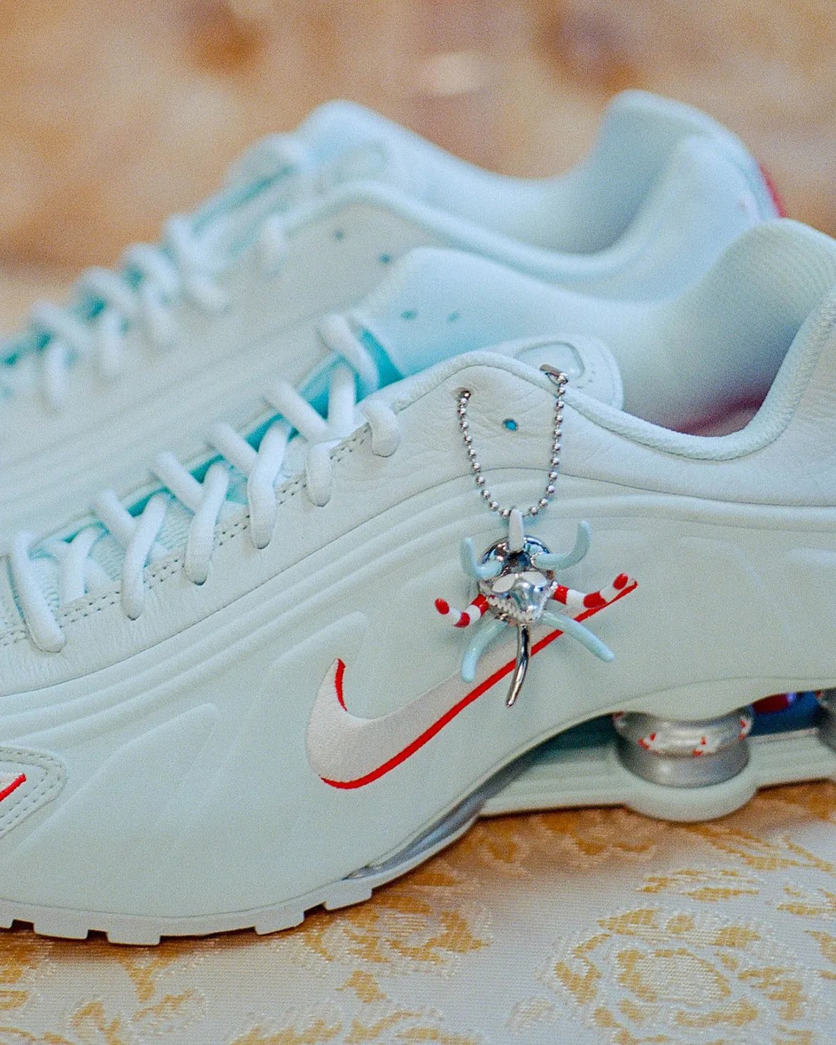 Nike Shox R4 Puerto Rico colorway featuring flag-inspired palette and Vejigante mask charm detail - detail view 2