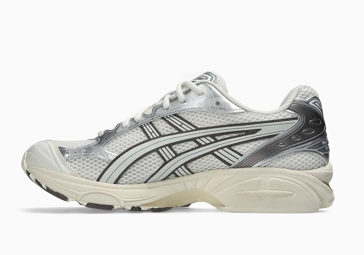 ASICS GEL-Kayano 14 in Cream and Cocoa Powder colorway, showcasing off-white mesh upper with metallic silver side panels and brushed cocoa heel detailing - detail view 2
